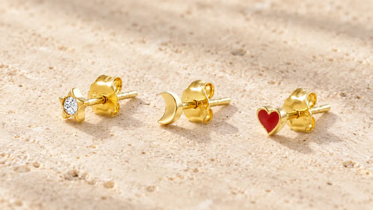 Gold-plated mini studs shaped like a star, moon and heart on light stone